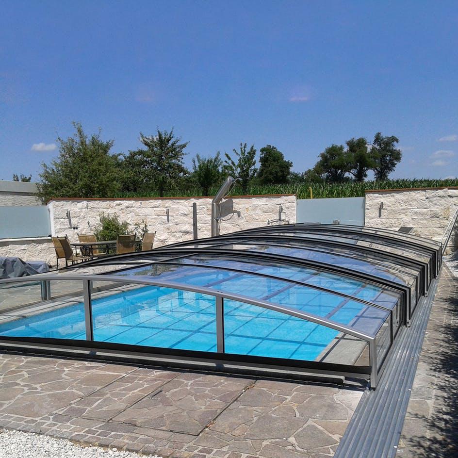 Modern contemporary swimming pool terrace with city view background 3d render There are wooden floor overlooking green lawn and metropolis